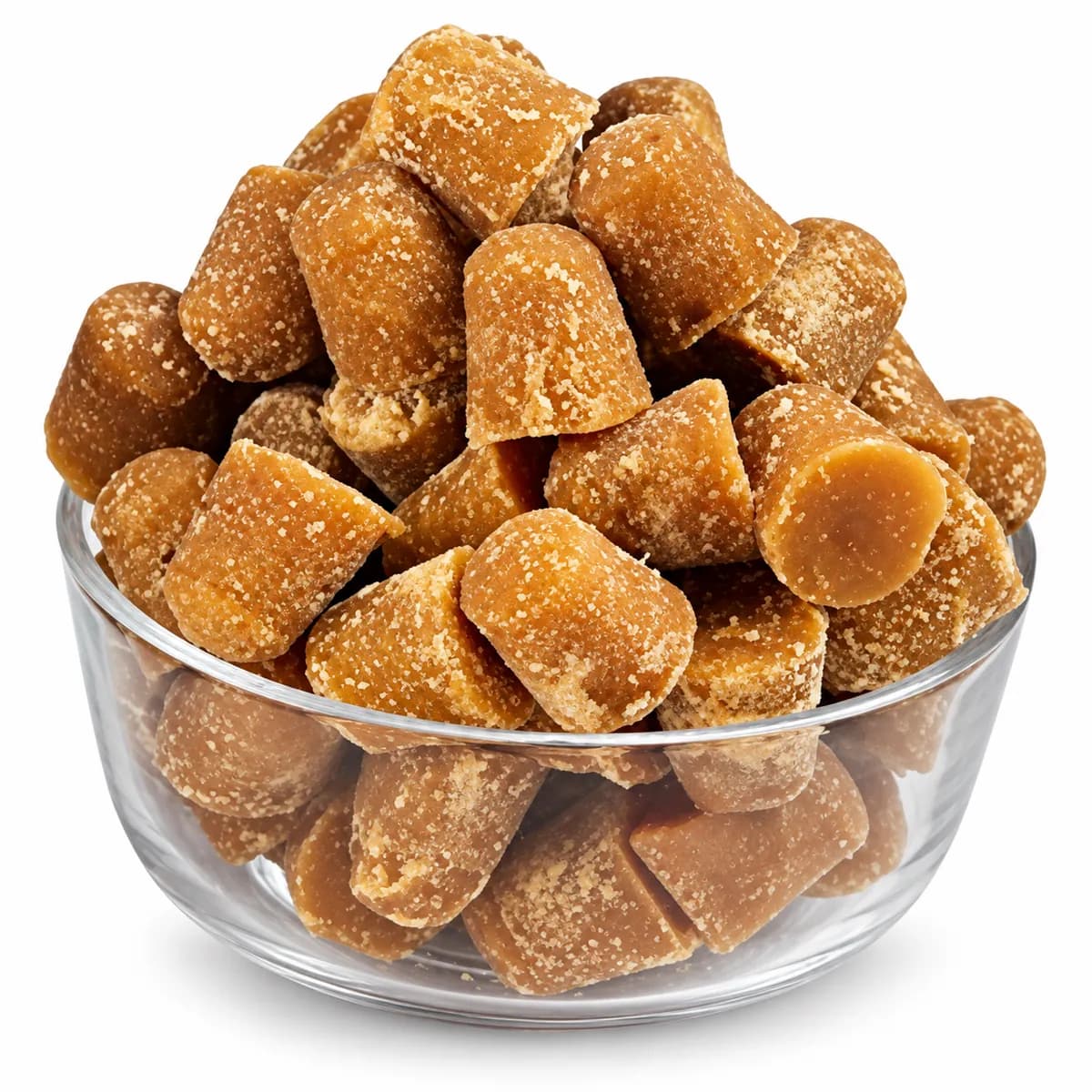 Organic brown jaggery cubes in a clear glass bowl